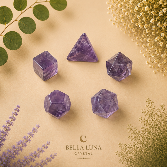 Five purple amethyst crystal geometric pendants, including pyramids and dodecahedrons, arranged on a beige background with decorative botanical elements and the Bella Luna Crystal logo at the bottom.