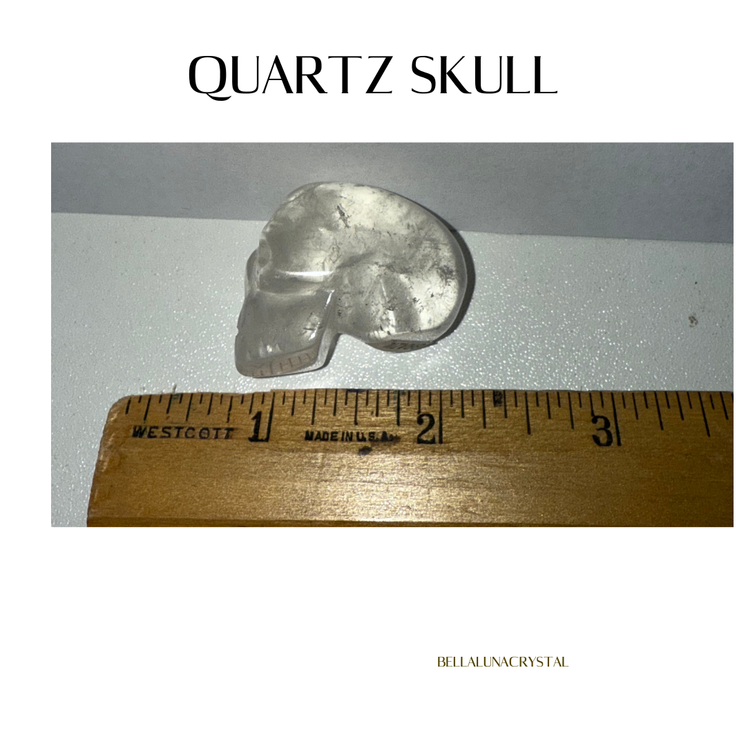 Quartz skull with a ruler for scale on a white background