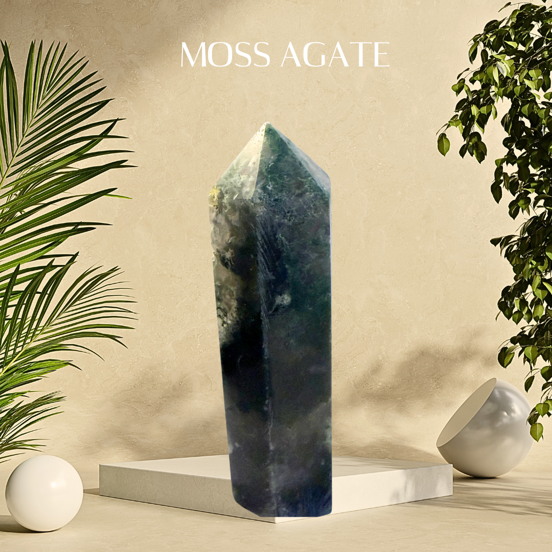 Moss Agate crystal on a beige platform with plants on either side