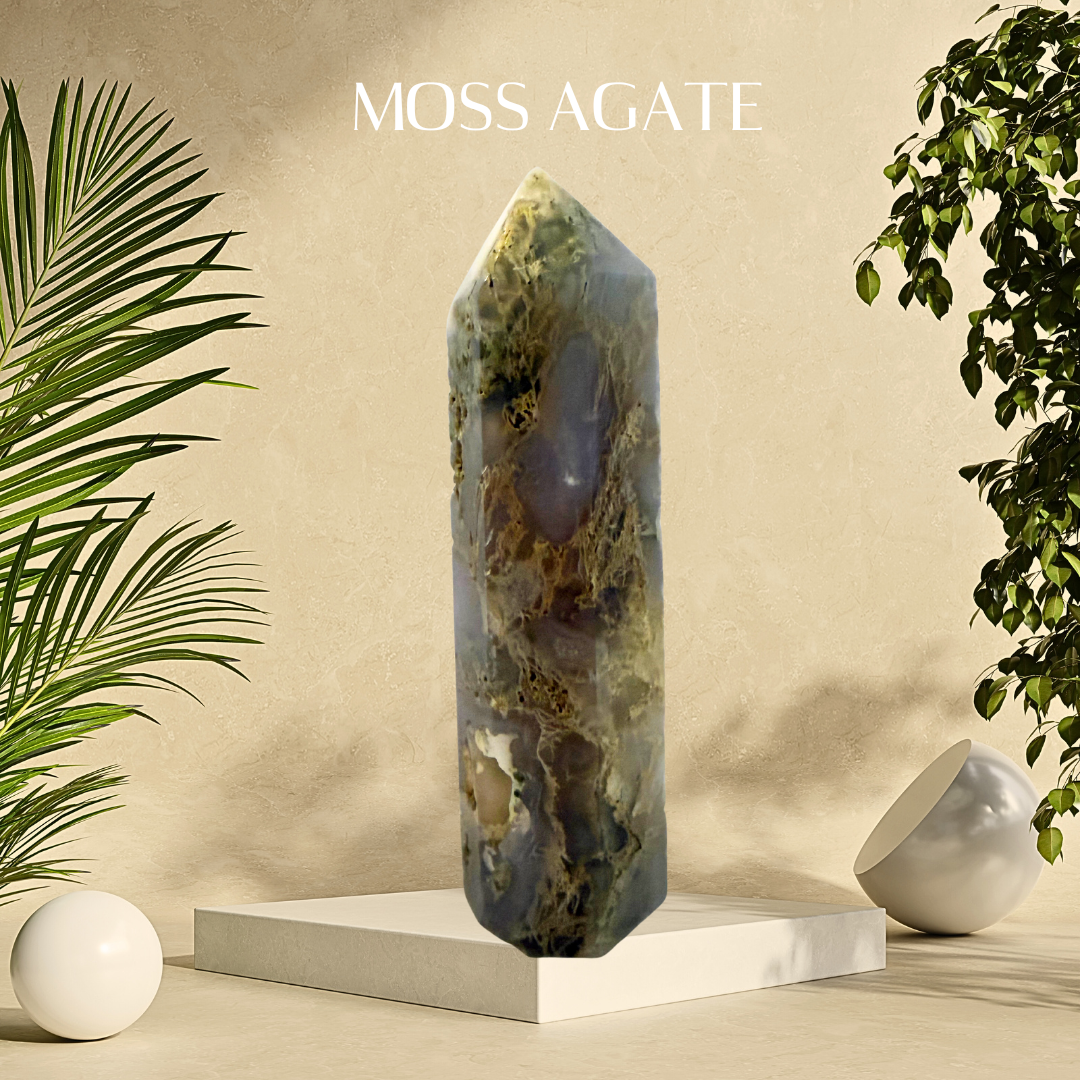 Moss agate crystal on a white pedestal with plants and a beige background