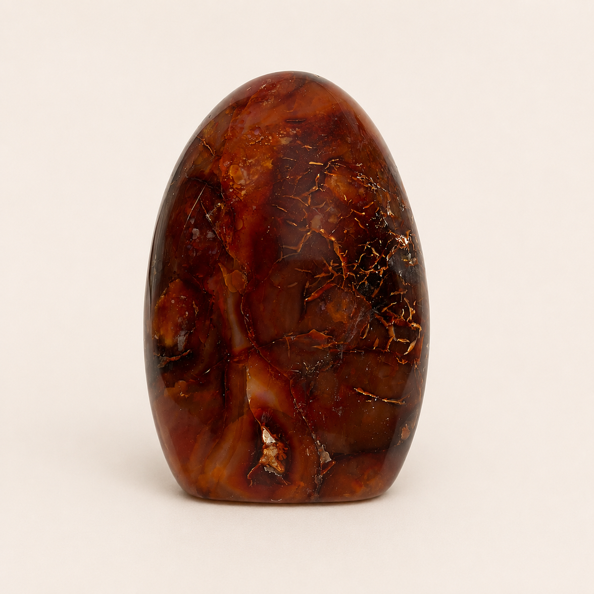 A polished brown agate egg with natural crystalline patterns, standing upright on a light beige background.