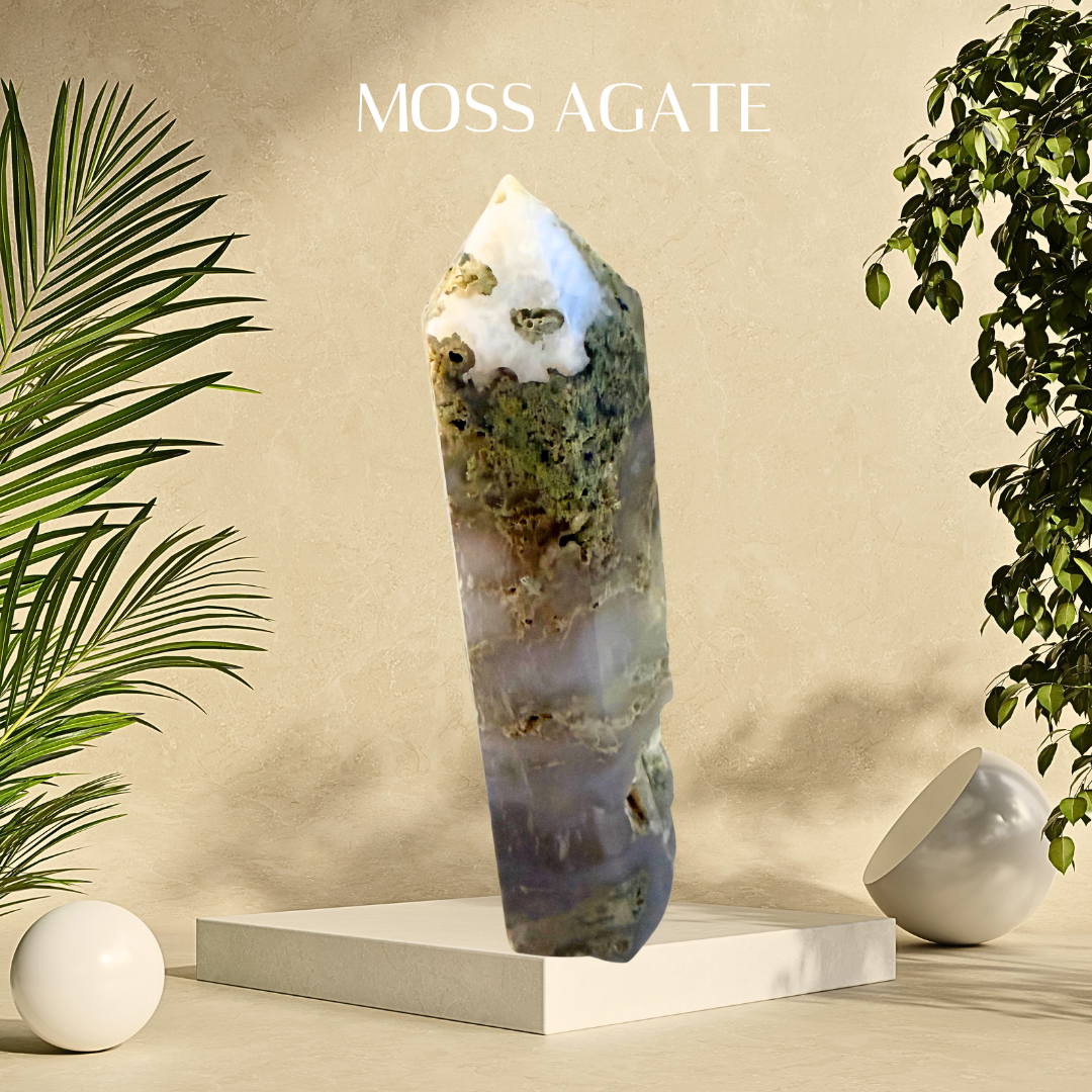 Moss agate crystal on a beige platform with plants on either side