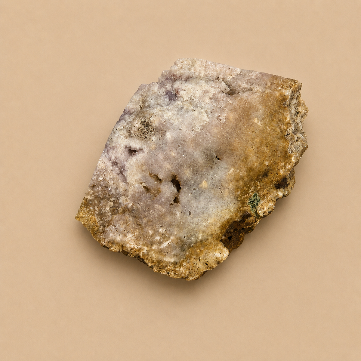 A raw mineral specimen with a mix of beige, brown, gray, and white crystalline textures, photographed on a solid beige background.