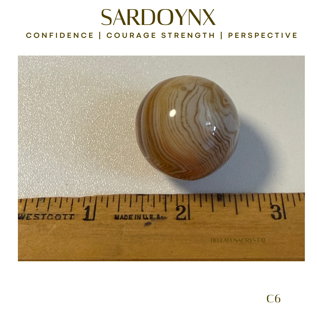 Brown and white patterned stone on a white background with a ruler for scale, featuring the brand 'Sardonyx'.