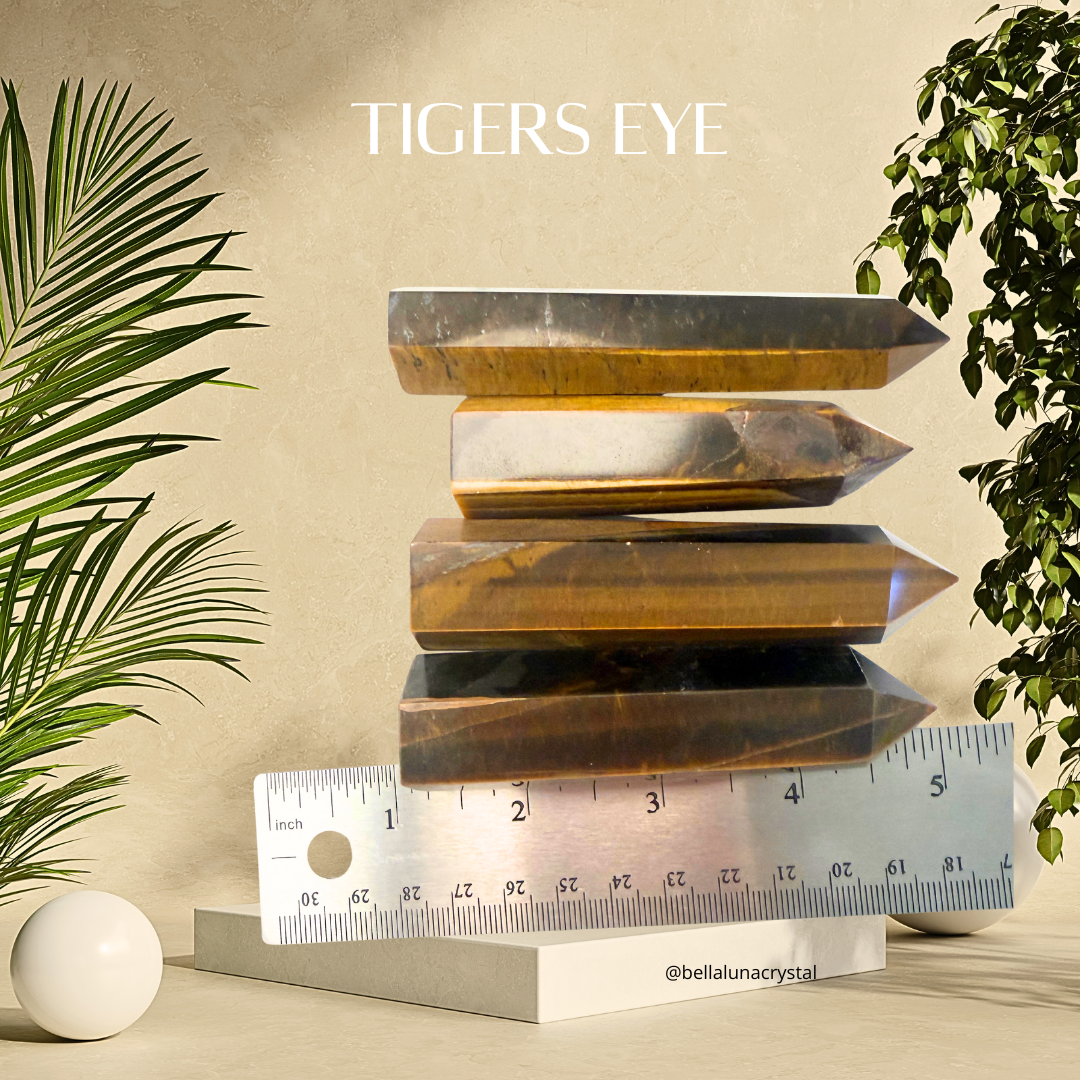 Stack of tigers eye crystals with a ruler for scale on a beige background