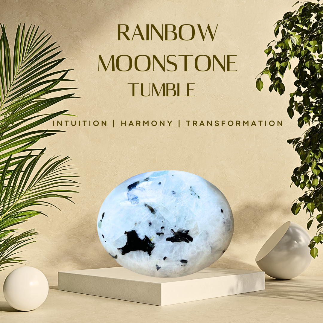 A polished Rainbow Moonstone tumble on a white stand, with a green plant in the background and a copper orb in the foreground.