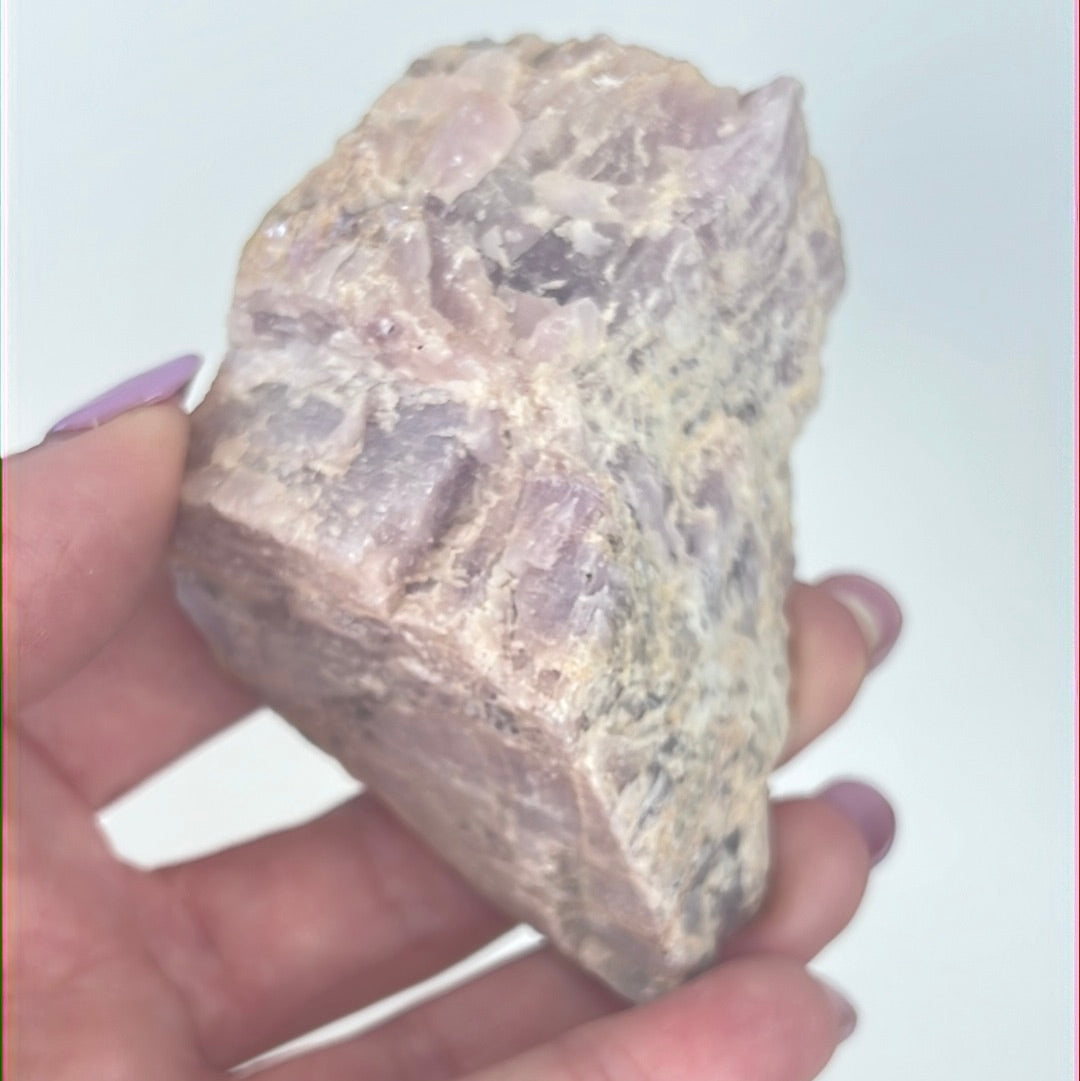 Rough Kunzite specimen with a deep purple color and natural crystalline patterns.